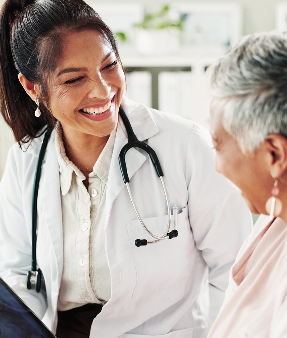 Doctor and patient smiling and discussing treatment.