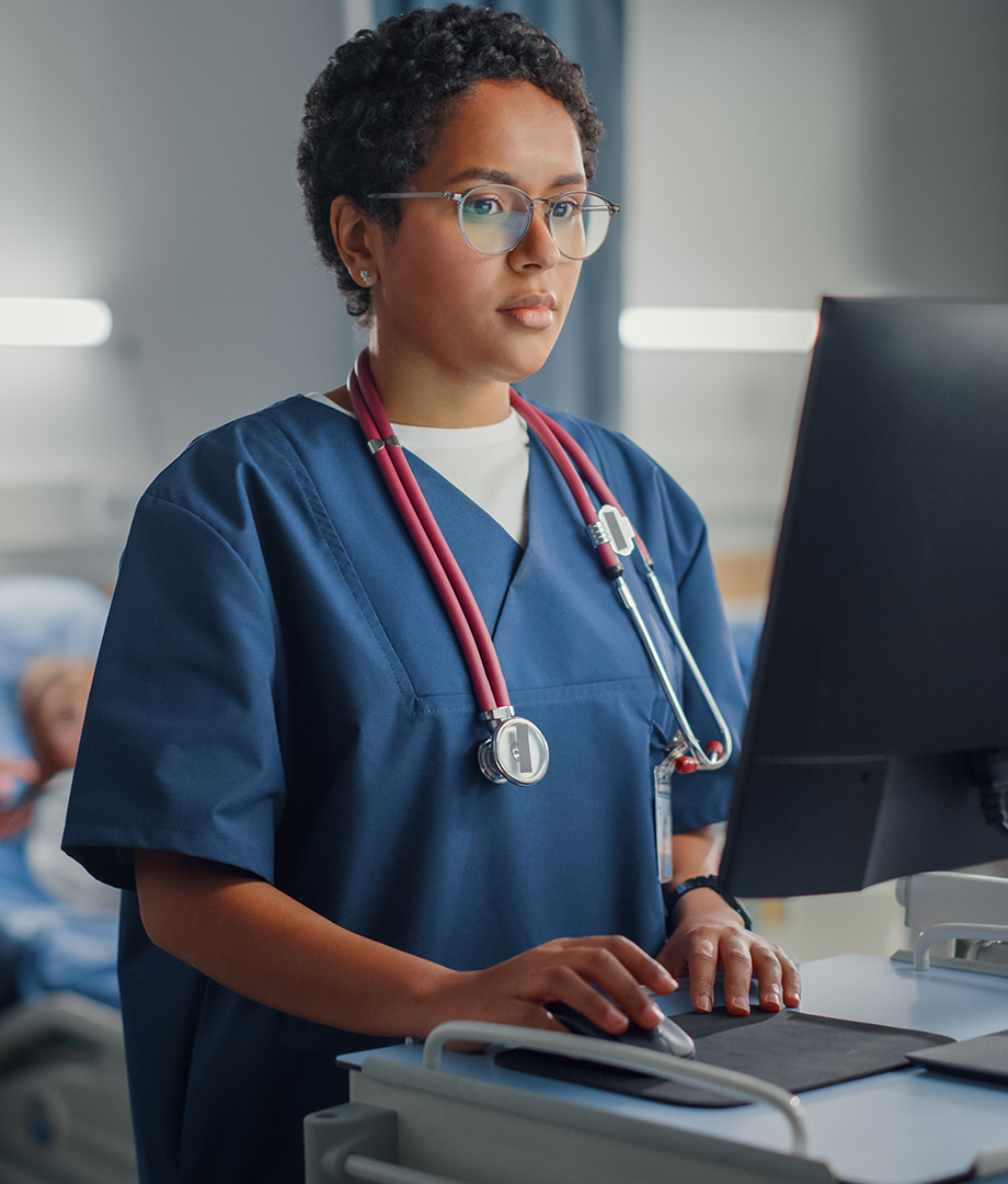 Nurse entering records into EHR system.