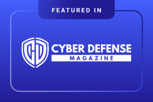 A blue graphic with white text reads Featured In Cyber Defense Magazine alongside a shield logo.