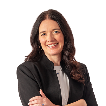 Jennifer Walen, with long dark hair, wearing a black blazer and white top, smiling with arms crossed against a plain light background, exuding the confidence and professionalism of an RCM executive.